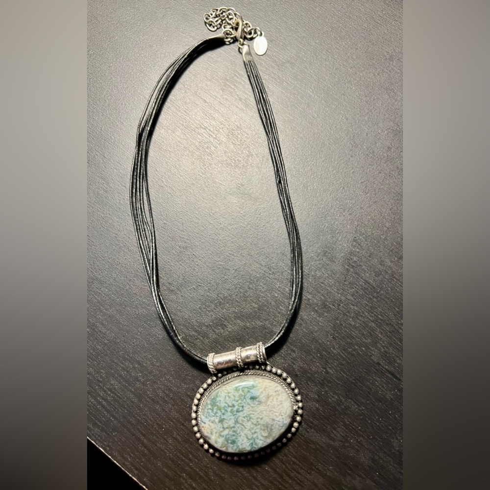 Silver set gemstone with black leather chain. 7.5” drop with a 3” extender.